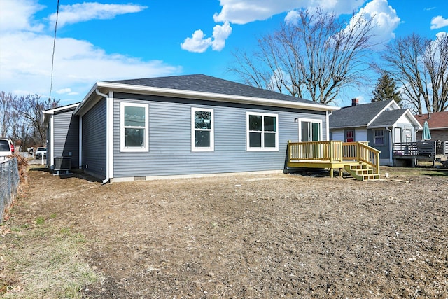 rear view of house with central AC and a deck