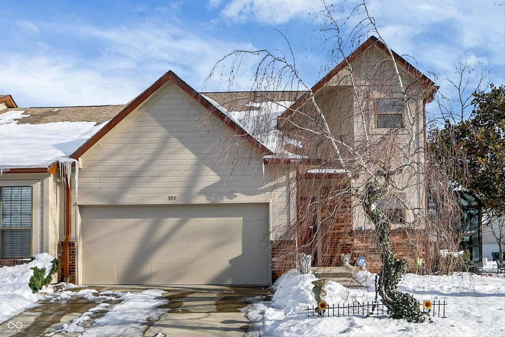 view of snow covered exterior with a garage