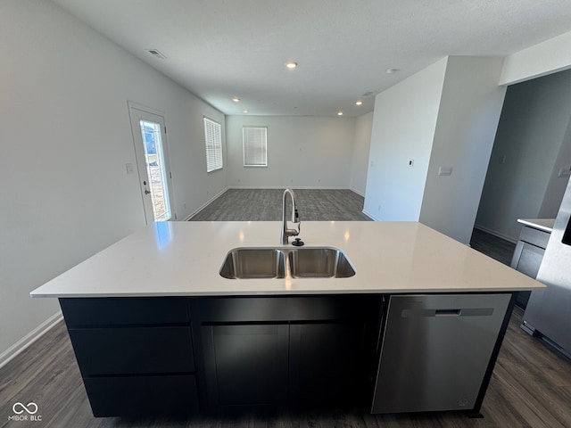 kitchen featuring sink, a kitchen island with sink, stainless steel dishwasher, and dark hardwood / wood-style floors