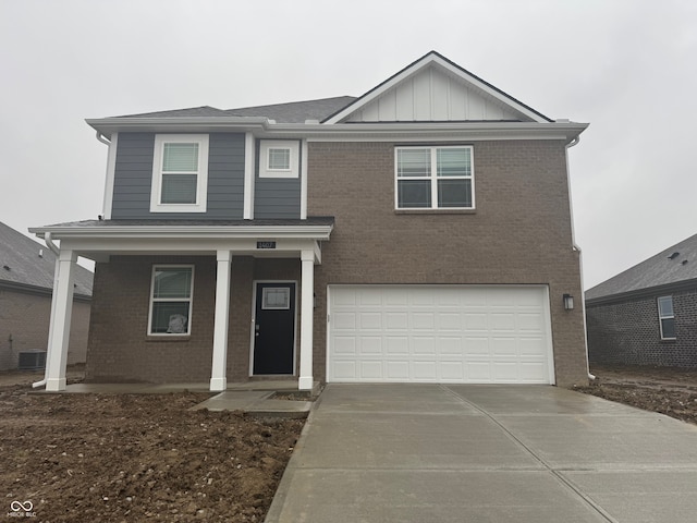 view of front of house with central AC unit and a garage