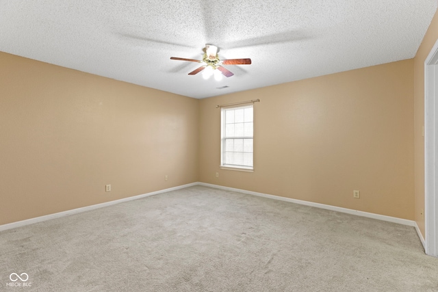 carpeted empty room with ceiling fan and a textured ceiling