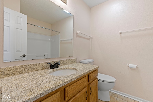 bathroom with vanity, a shower, tile patterned floors, and toilet