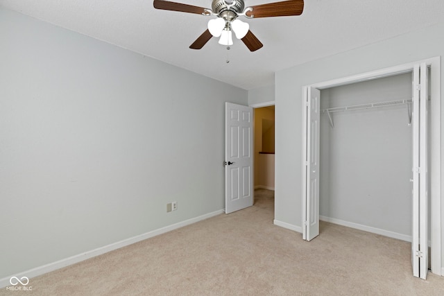 unfurnished bedroom with ceiling fan, light colored carpet, and a closet