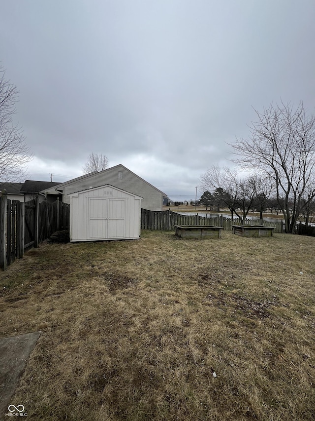 view of yard featuring a pool and a shed