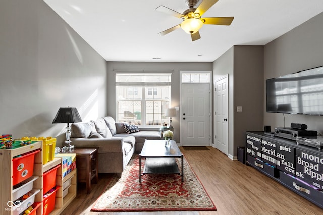 2231 Colfax Ln, Indianapolis, IN 46260 - living room with wood finished floors, ceiling fan, and baseboards