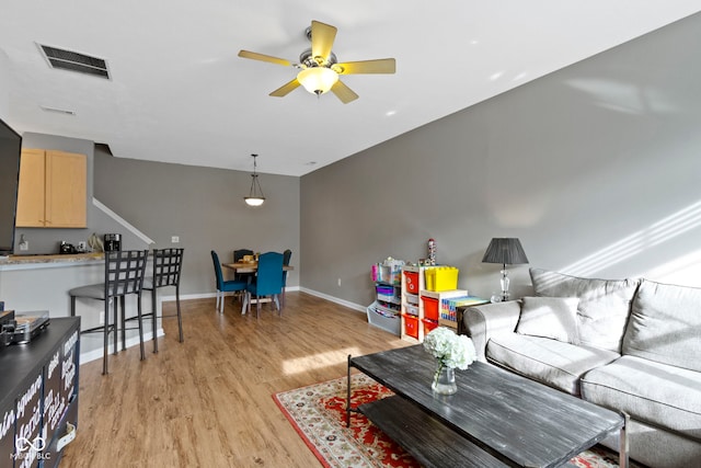 2231 Colfax Ln, Indianapolis, IN 46260 - living area with light wood-type flooring, ceiling fan, and baseboards