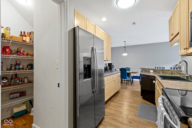 2231 Colfax Ln, Indianapolis, IN 46260 - kitchen featuring appliances with stainless steel finishes, a sink, light brown cabinets, and light wood finished floors