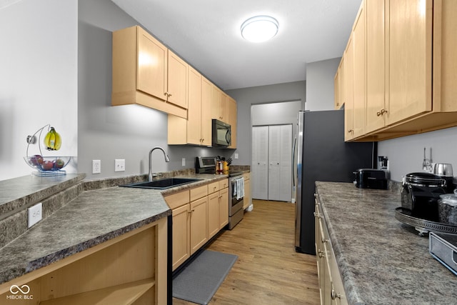 2231 Colfax Ln, Indianapolis, IN 46260 - kitchen with stainless steel appliances, a sink, light wood finished floors, and light brown cabinets