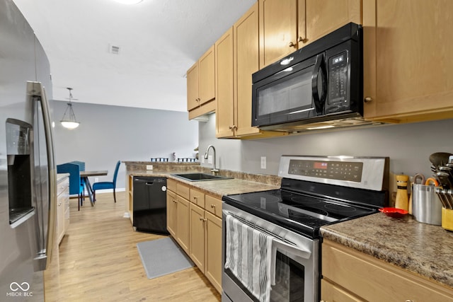 2231 Colfax Ln, Indianapolis, IN 46260 - kitchen featuring black appliances, a sink, light wood finished floors, light brown cabinetry, and decorative light fixtures