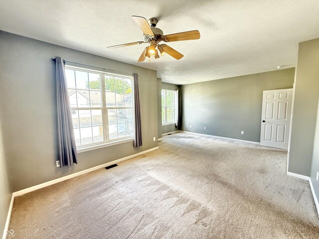 2231 Colfax Ln, Indianapolis, IN 46260 - carpeted empty room with a ceiling fan and a textured ceiling