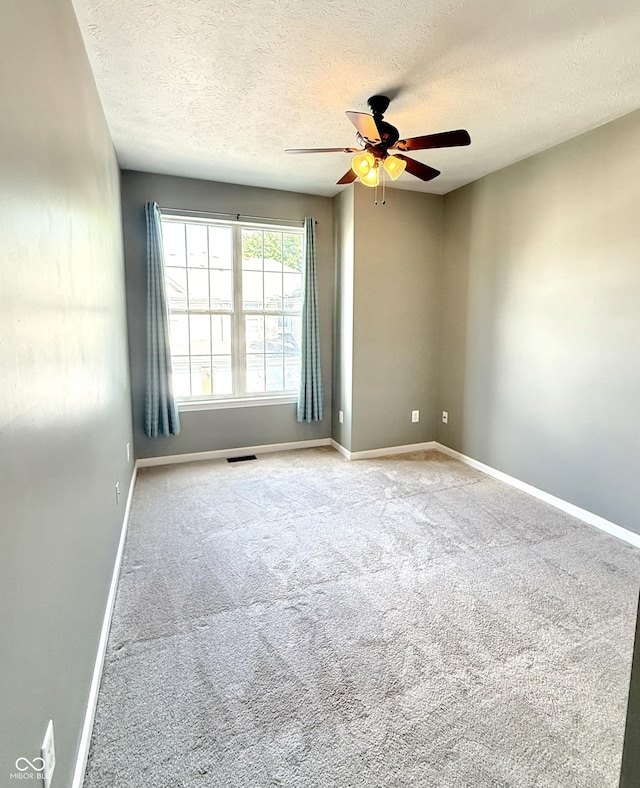2231 Colfax Ln, Indianapolis, IN 46260 - spare room featuring a ceiling fan, a textured ceiling, and carpet floors