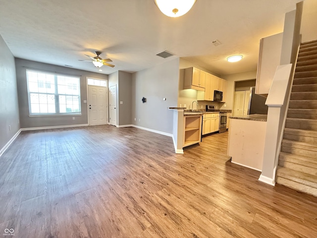 2231 Colfax Ln, Indianapolis, IN 46260 - kitchen featuring black microwave, electric range, a ceiling fan, and light wood-style floors