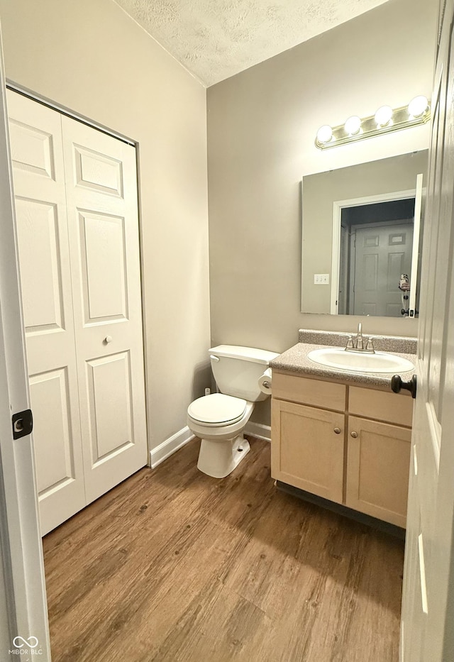 2231 Colfax Ln, Indianapolis, IN 46260 - half bath with a textured ceiling, wood finished floors, and vanity