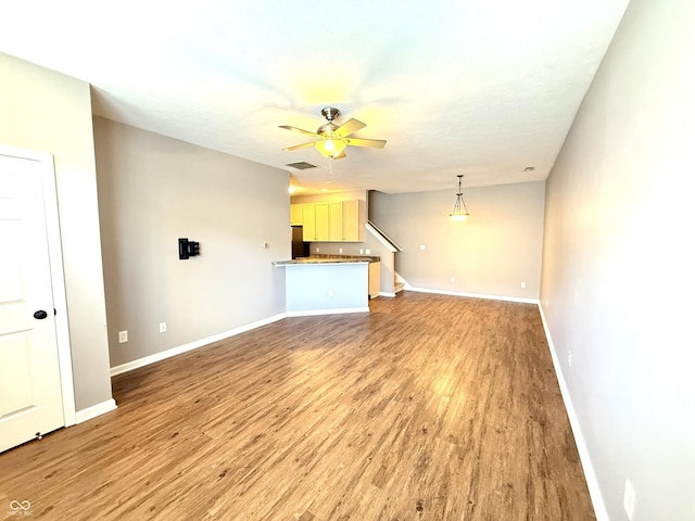 2231 Colfax Ln, Indianapolis, IN 46260 - unfurnished living room with light wood-style flooring, a ceiling fan, and stairs