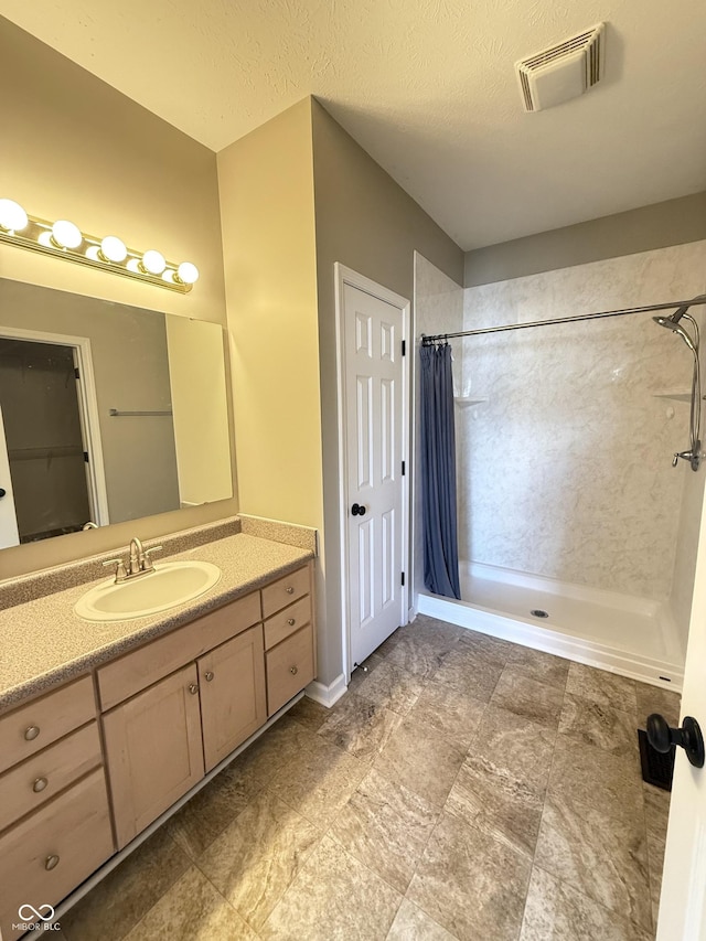 2231 Colfax Ln, Indianapolis, IN 46260 - bathroom with curtained shower, vanity, and a textured ceiling