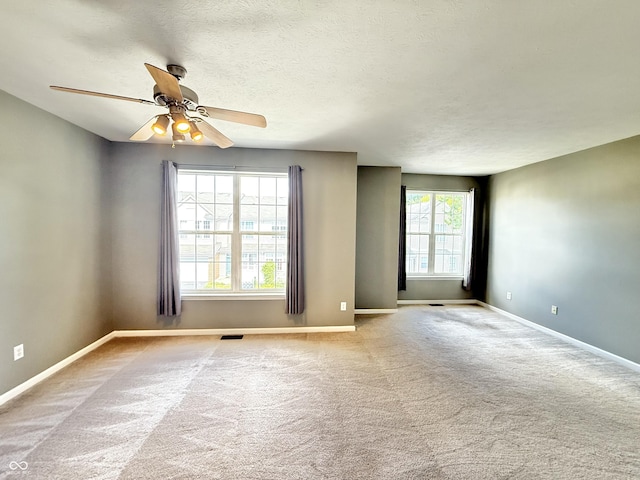 2231 Colfax Ln, Indianapolis, IN 46260 - carpeted empty room featuring a ceiling fan and a textured ceiling