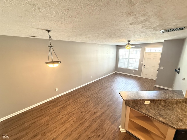2231 Colfax Ln, Indianapolis, IN 46260 - unfurnished living room featuring dark wood-style flooring, ceiling fan, and a textured ceiling