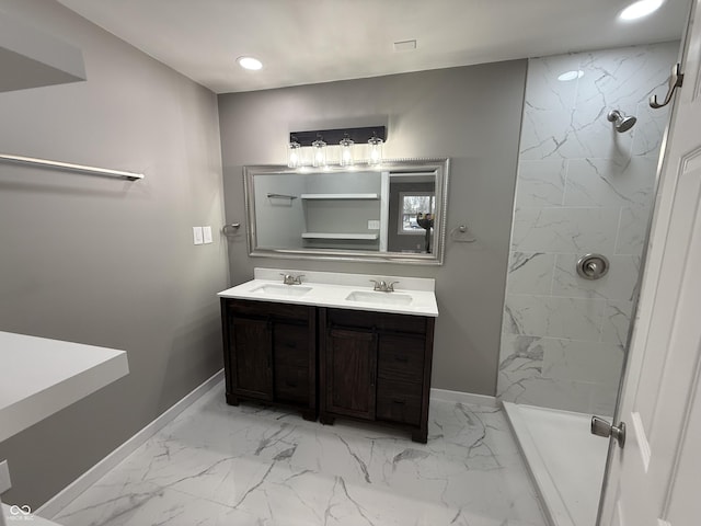 bathroom with vanity and a tile shower