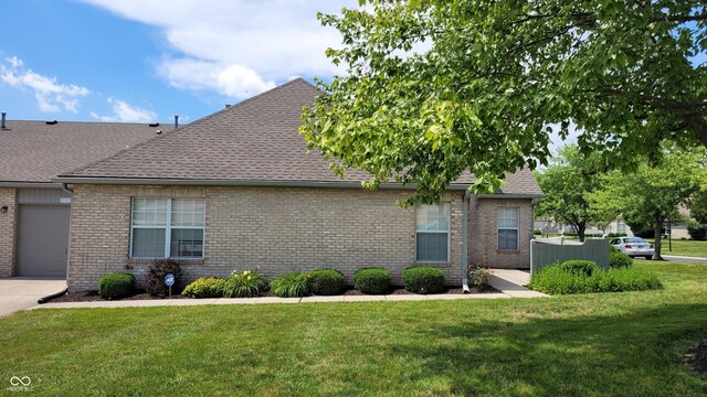 5850 Bradston Way, Indianapolis, IN 46237 - view of side of property featuring a shingled roof, brick siding, and a lawn