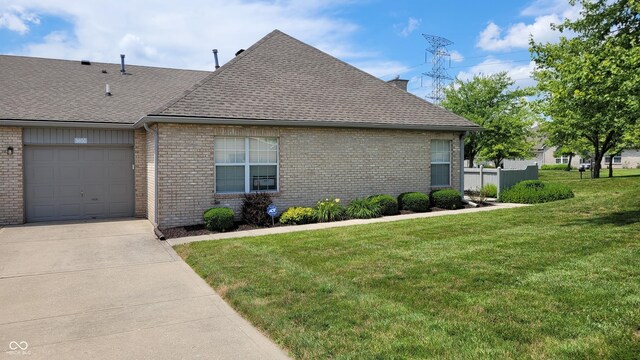 5850 Bradston Way, Indianapolis, IN 46237 - view of side of property featuring a shingled roof, brick siding, a yard, concrete driveway, and a chimney