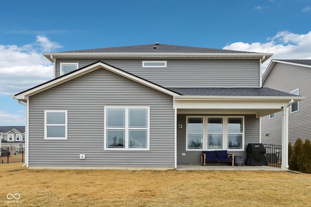 rear view of house with a yard and a patio area