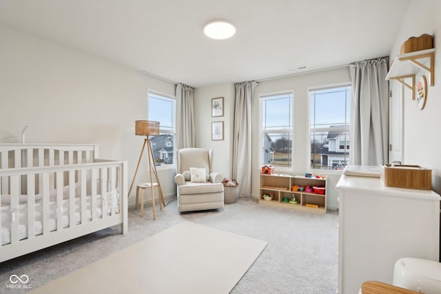 carpeted bedroom with a crib