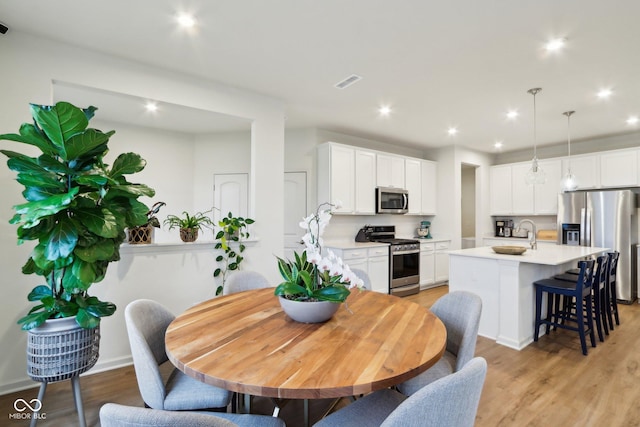 dining room with light hardwood / wood-style flooring