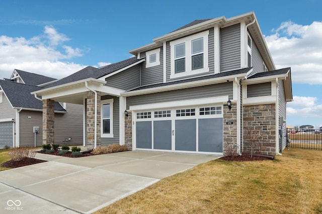 craftsman house with a garage and a front yard