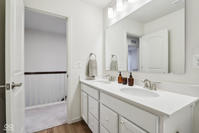 bathroom with hardwood / wood-style flooring and vanity