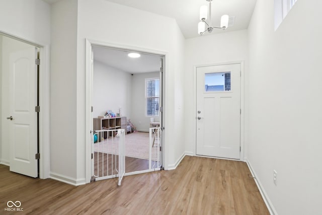 foyer featuring an inviting chandelier and light wood-type flooring