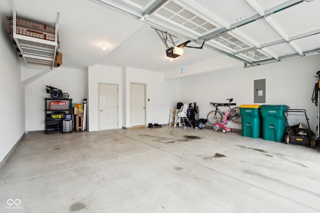 garage with a garage door opener and electric panel