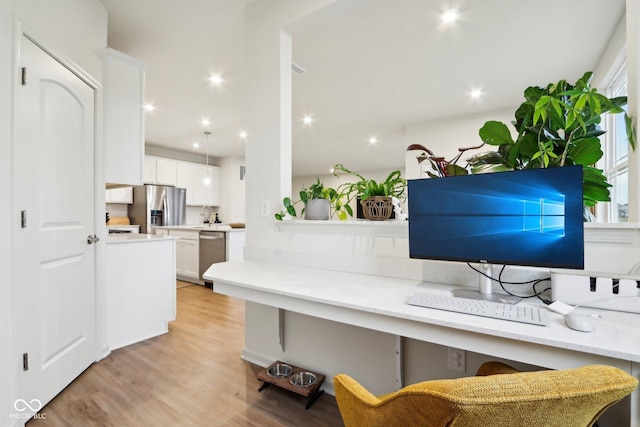 home office featuring sink and light wood-type flooring