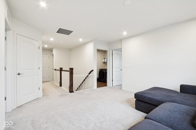 carpeted living room with washer / clothes dryer