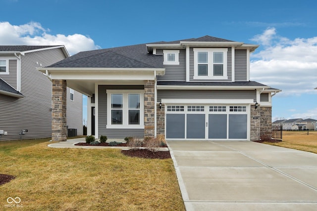 view of front of house with central AC, a garage, and a front yard