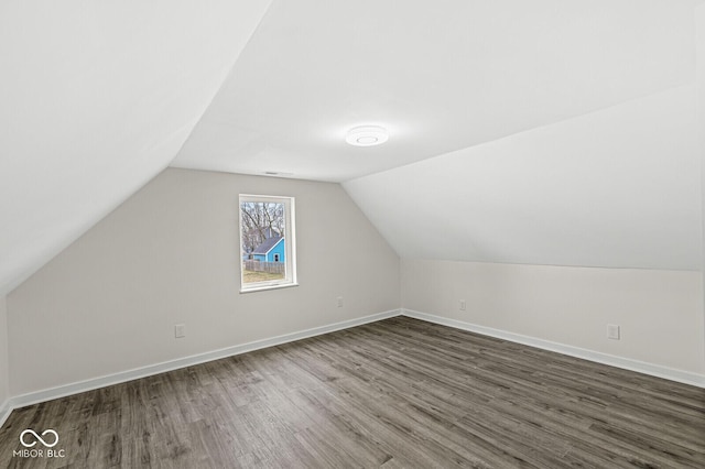 additional living space with lofted ceiling and dark wood-type flooring