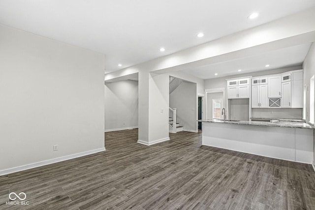 unfurnished living room featuring dark hardwood / wood-style flooring and sink