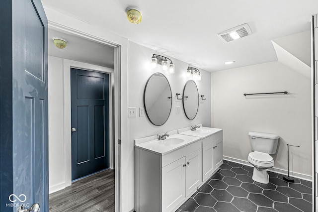 bathroom with vanity, tile patterned flooring, and toilet