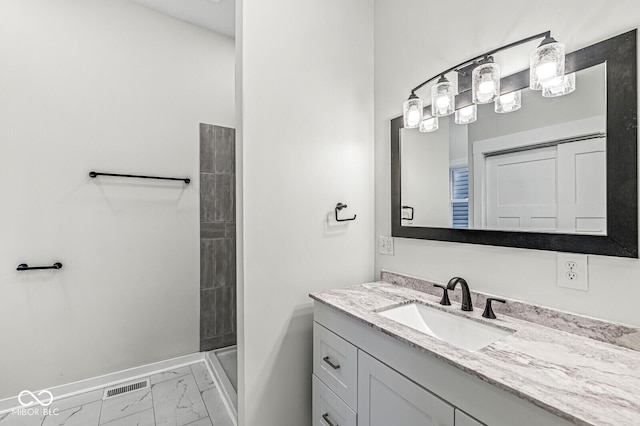 bathroom with walk in shower and vanity