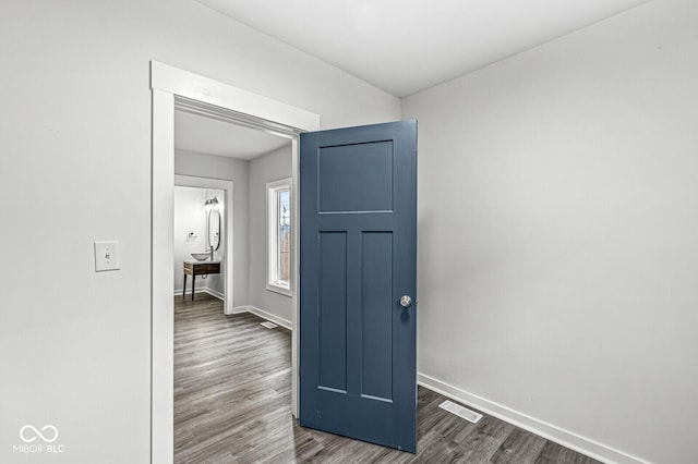 hall with dark wood-type flooring