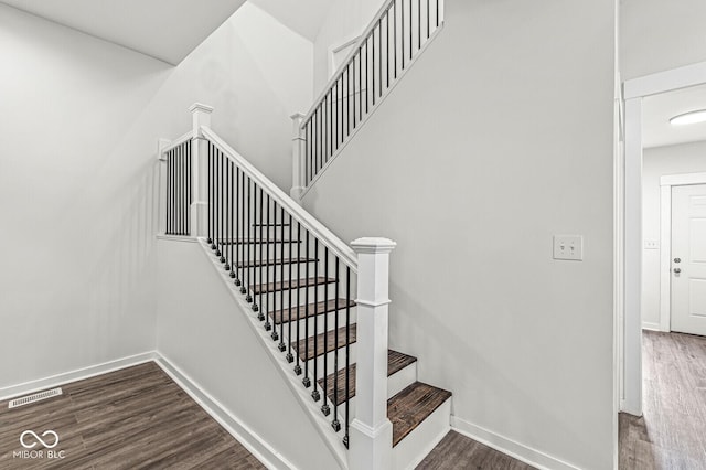 stairway with hardwood / wood-style floors