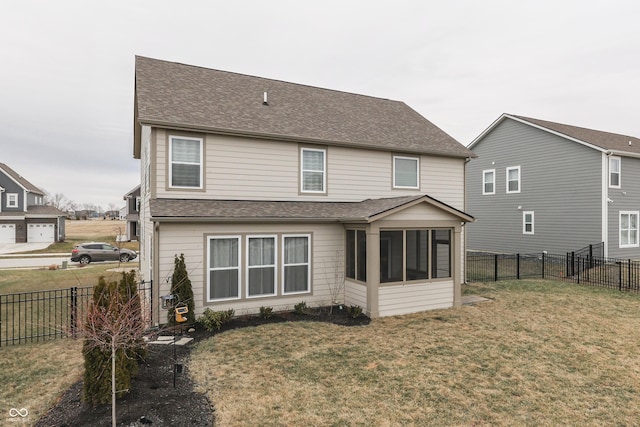 back of house featuring a sunroom and a yard