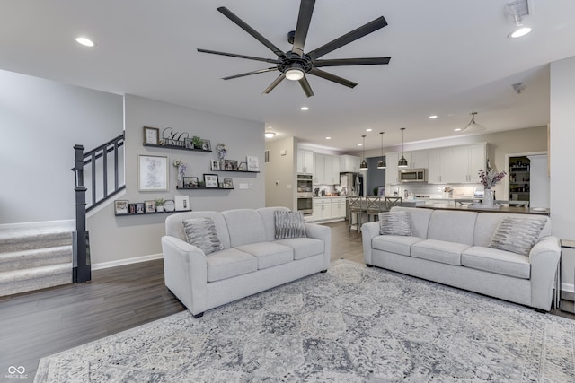 living room with ceiling fan and hardwood / wood-style floors