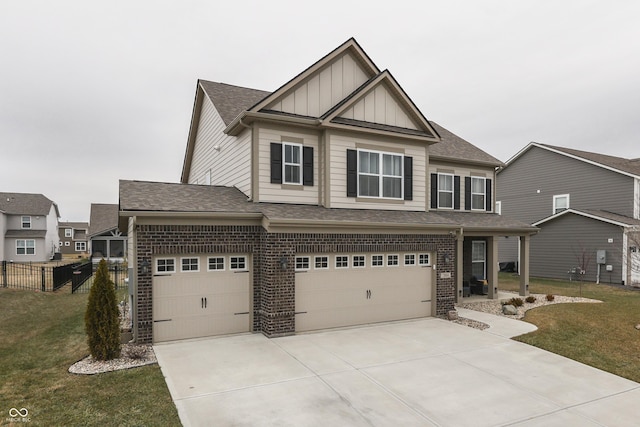 craftsman-style home featuring a garage and a front lawn