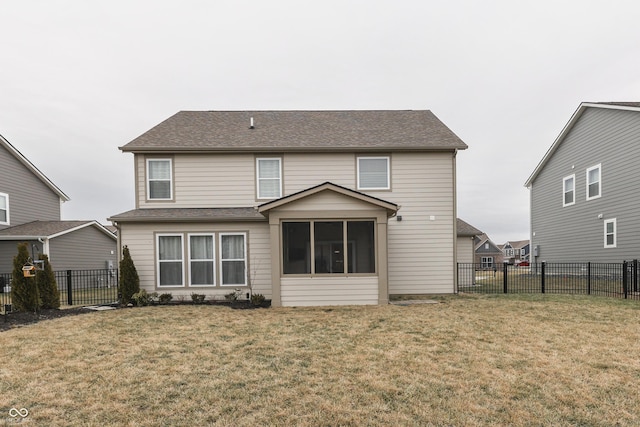 rear view of house featuring a yard