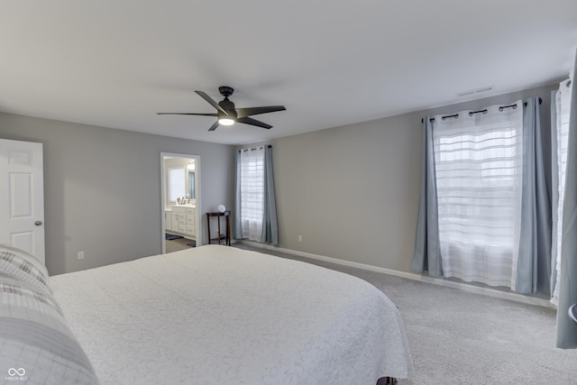 carpeted bedroom with ceiling fan and ensuite bathroom