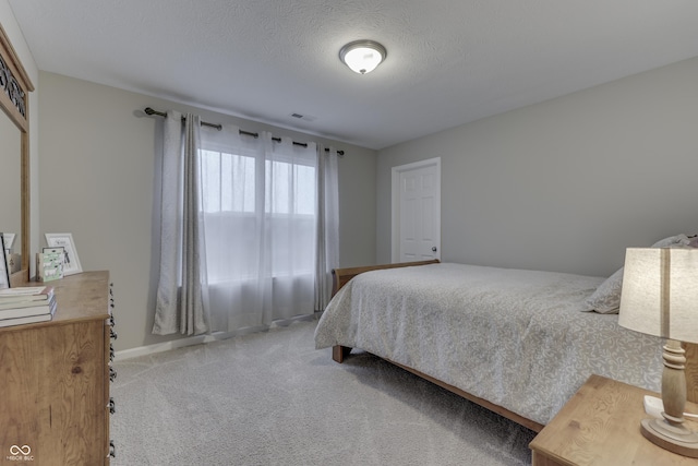 carpeted bedroom with a textured ceiling