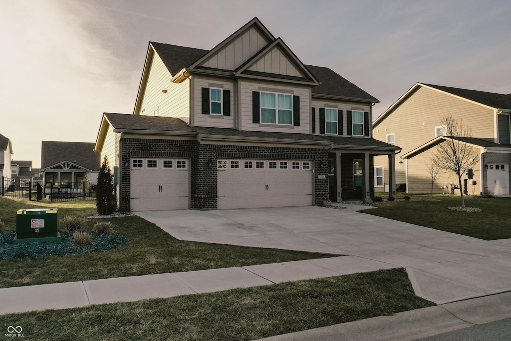 view of front of home featuring a garage and a front lawn