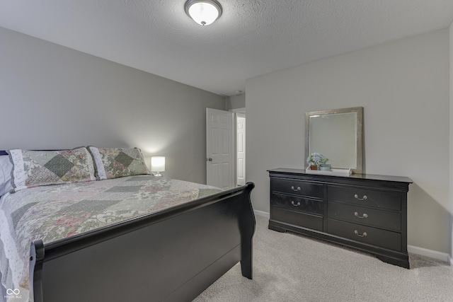 carpeted bedroom with a textured ceiling