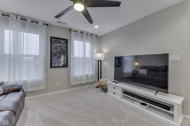 living room featuring carpet floors and ceiling fan