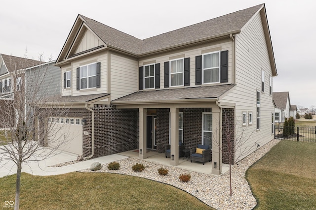 view of front of house featuring a garage, a patio area, and a front yard